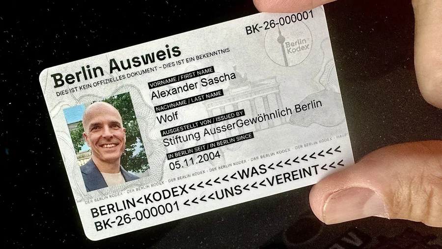 Berlin Ausweis in einer Hand, mit Foto, Name und dem Hinweis, dass dies kein offizielles Dokument ist